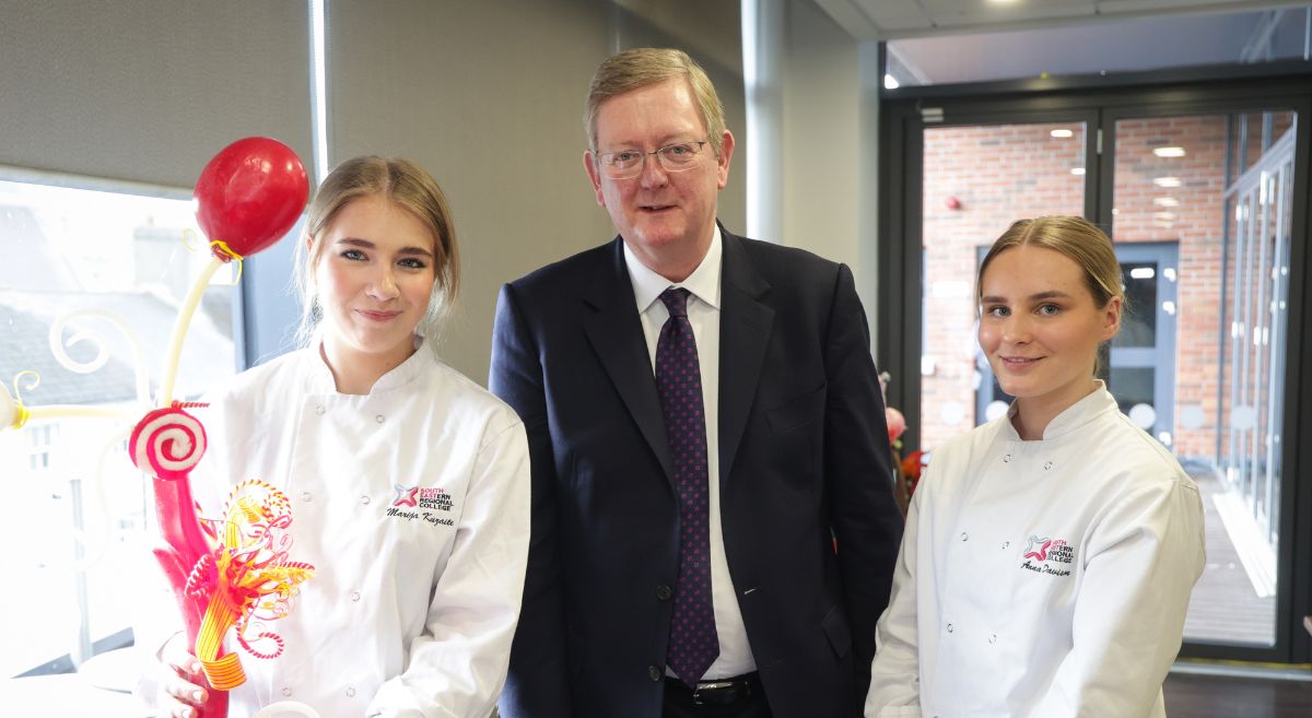 Marija  Kuzaite, Level 3 Patisserie and Confectionery, (left) shows her gold medal winning creation which came first in the UK Worldskills Competition this year to Lord Caine, and fellow student Anna Davison at the SERC Lisburn Campus.